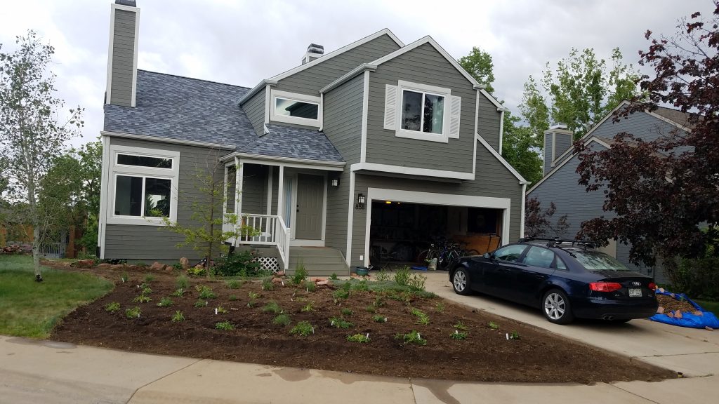 house with newly planted and mulched front yard garden