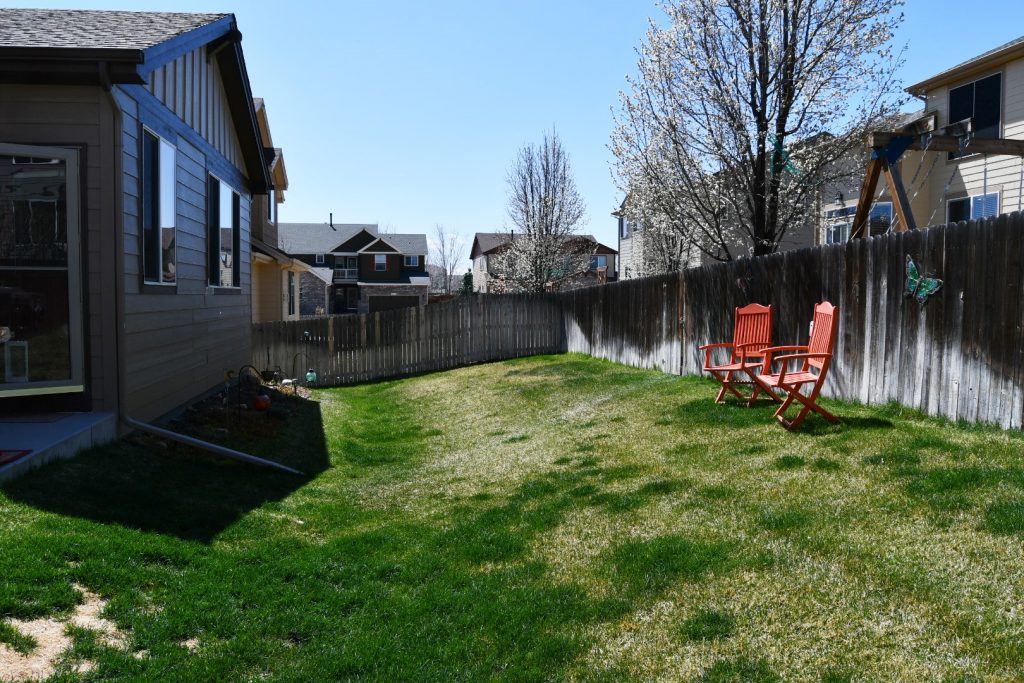 Backyard with house and lawn chairs