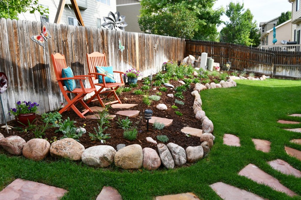 Garden planted and mulched with rock edging and stone path